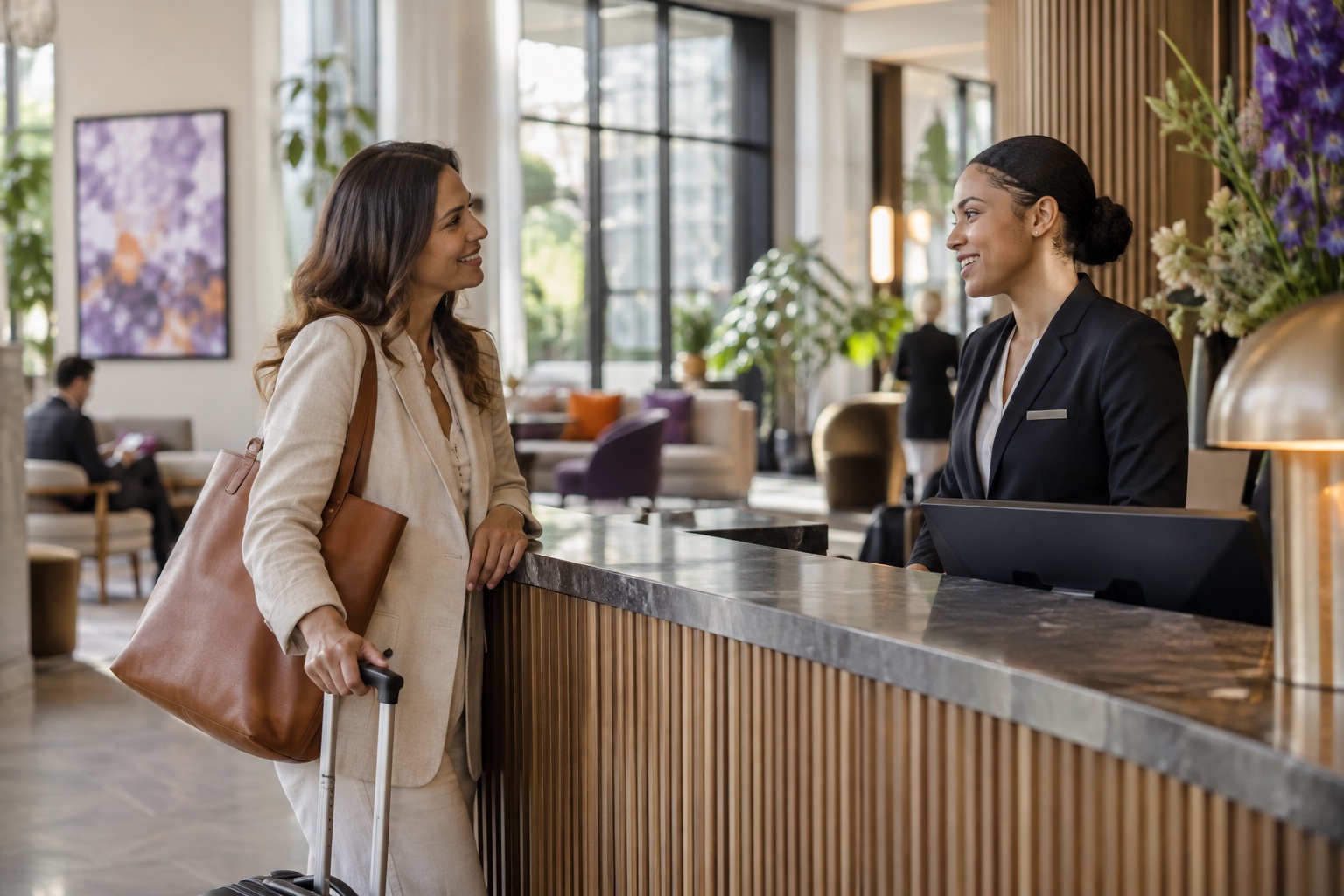 A hotel guest speaks with a member of the service team.